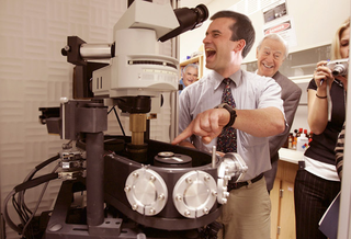 Scientists yuk it up over the atom's ridiculous size.